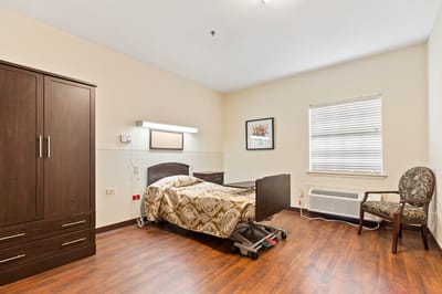 Bright private room with a bed and chair