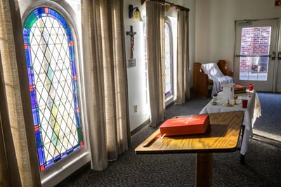 Interior view of a serene chapel with stained glass windows