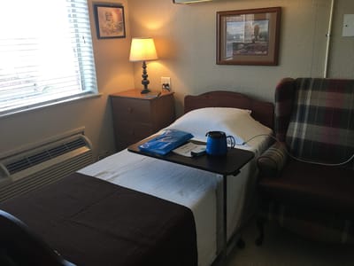 Cozy resident room with a bed and lamp