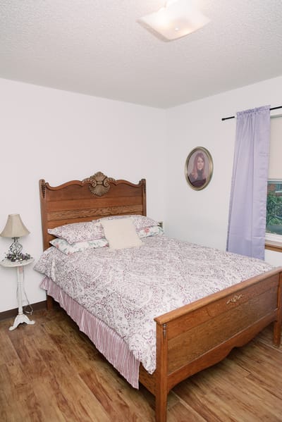 Cozy bedroom with a large wooden bed and decorative bedding
