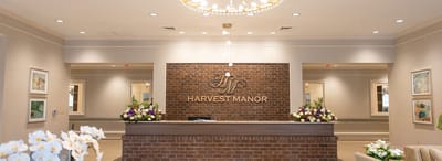 Reception area with floral arrangements and a brick feature wall