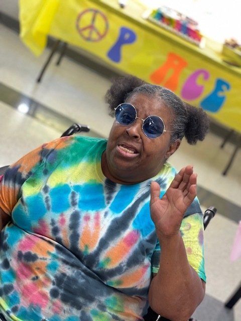 Resident in colorful attire enjoying an activity