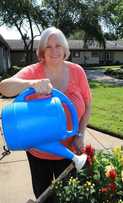 Resident watering flowers in the garden