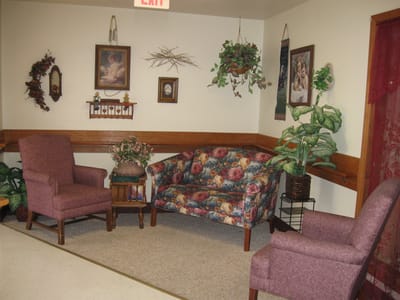 Cozy seating area with floral couch and armchairs
