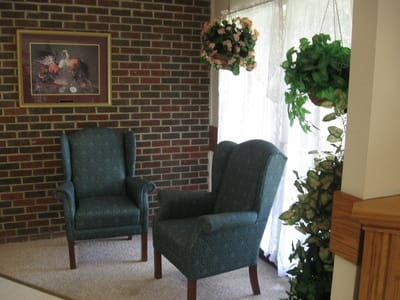 Cozy common area with two chairs and plants