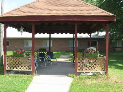 Cozy outdoor gazebo with seating and flowers