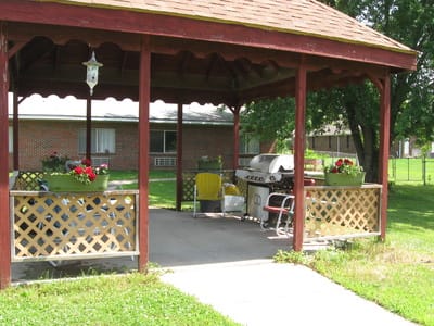 Outdoor patio area with seating and grill