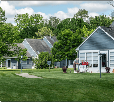 Exterior view of a senior living facility with lush landscaping