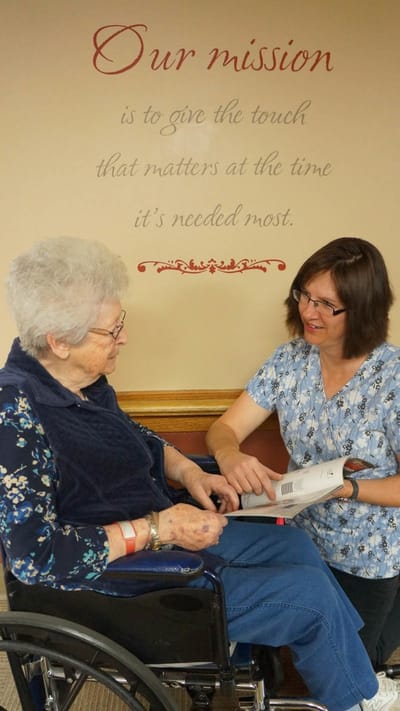 Staff member engaging with a resident in a cozy setting