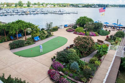 Resident enjoying the garden area with boats in the background