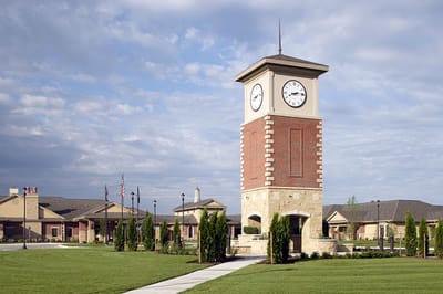Brookestone Meadows Rehabilitation and, Nursing Home in Elkhorn, NE — Clock tower surrounded by landscaped grounds and buildings