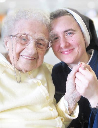 Elderly resident smiling with a staff member