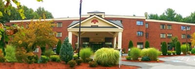 Exterior view of a senior living facility with landscaped gardens