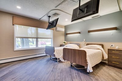 Well-appointed private room with two beds and TVs