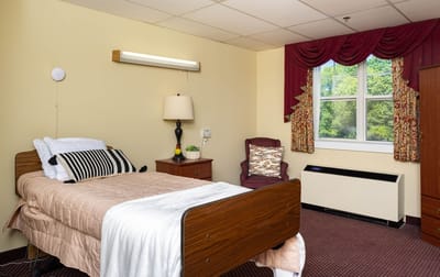Cozy resident room with a bed and seating area
