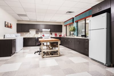 Bright kitchen area with appliances and seating