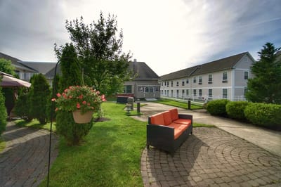Outdoor seating area with a garden and pathways