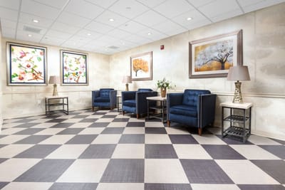 Bright common area with stylish blue chairs and artwork