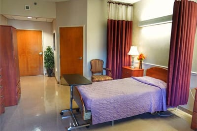A spacious resident room with a single bed and window