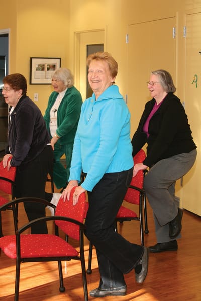 Seniors participating in a seated exercise class