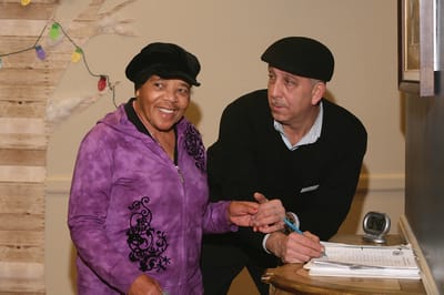 Senior woman and staff member interacting in the facility