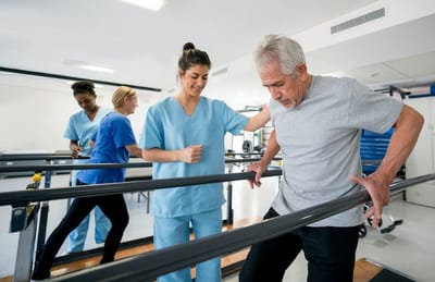 Therapist assisting a senior during rehabilitation