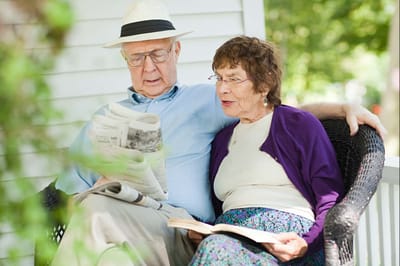 Couple reading together on a porch