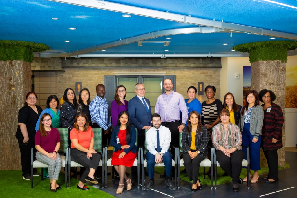 Staff members posing in a modern common area
