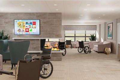 Bright common area with seating and a TV
