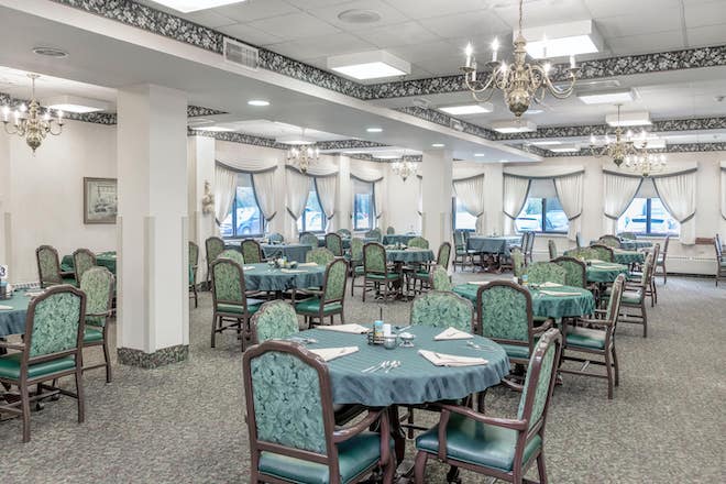 Dining area with tables and chairs set for meals