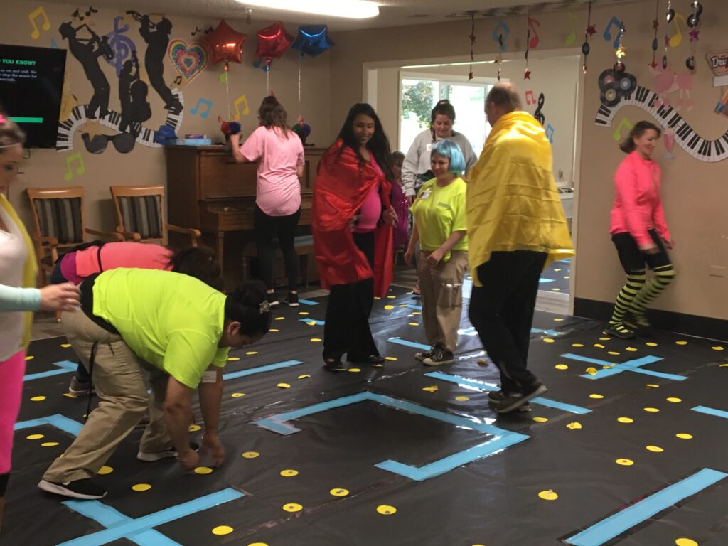 Residents and staff participating in an indoor activity