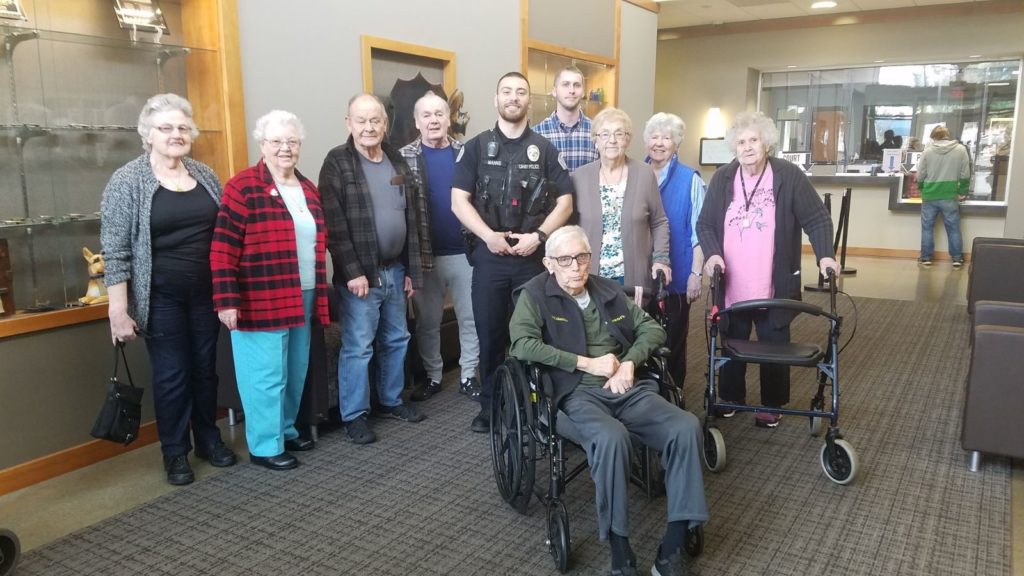 Residents and staff posing together in a common area