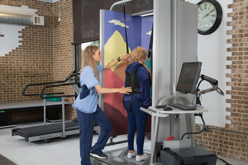 Therapist assisting a resident in a rehabilitation setup