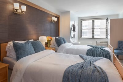 Bright resident room with two beds and modern design
