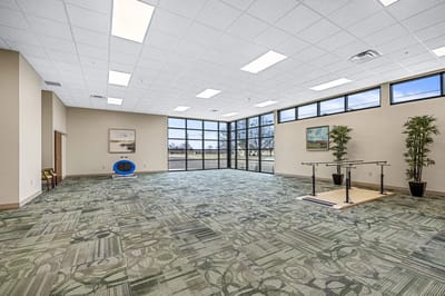Bright activity room with large windows and open space