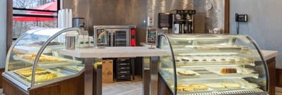 Café display with a variety of pastries and desserts