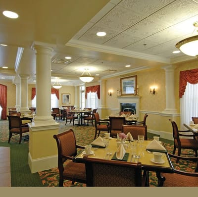 Elegant dining room with tables set for residents