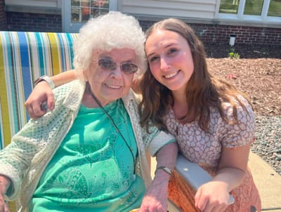 Resident and staff member enjoying time outdoors together