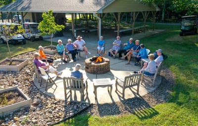 Residents gathered around a fire pit in a social area