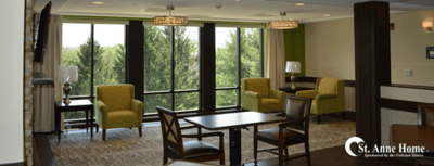 A bright common area with chairs and large windows