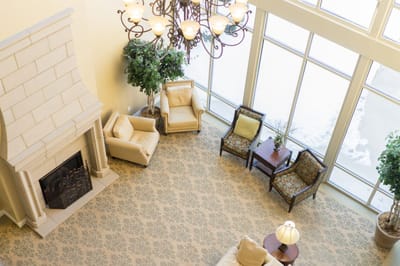 Bright common area with comfortable seating and a fireplace