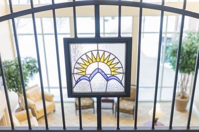 Stained glass window above a cozy common area