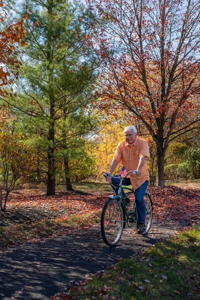 Senior man riding a bike in a colorful outdoor space