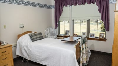 Cozy resident room with bed and personal decorations
