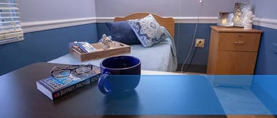 Cozy resident room with a book and coffee cup