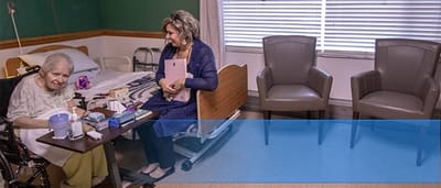 Caregiver interacting with a resident in a room