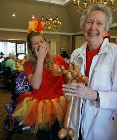 Residents enjoying a festive activity with balloons
