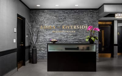 Reception area with a rock feature wall and flowers