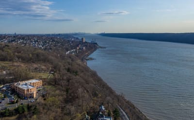 Aerial view of a senior living facility by the river