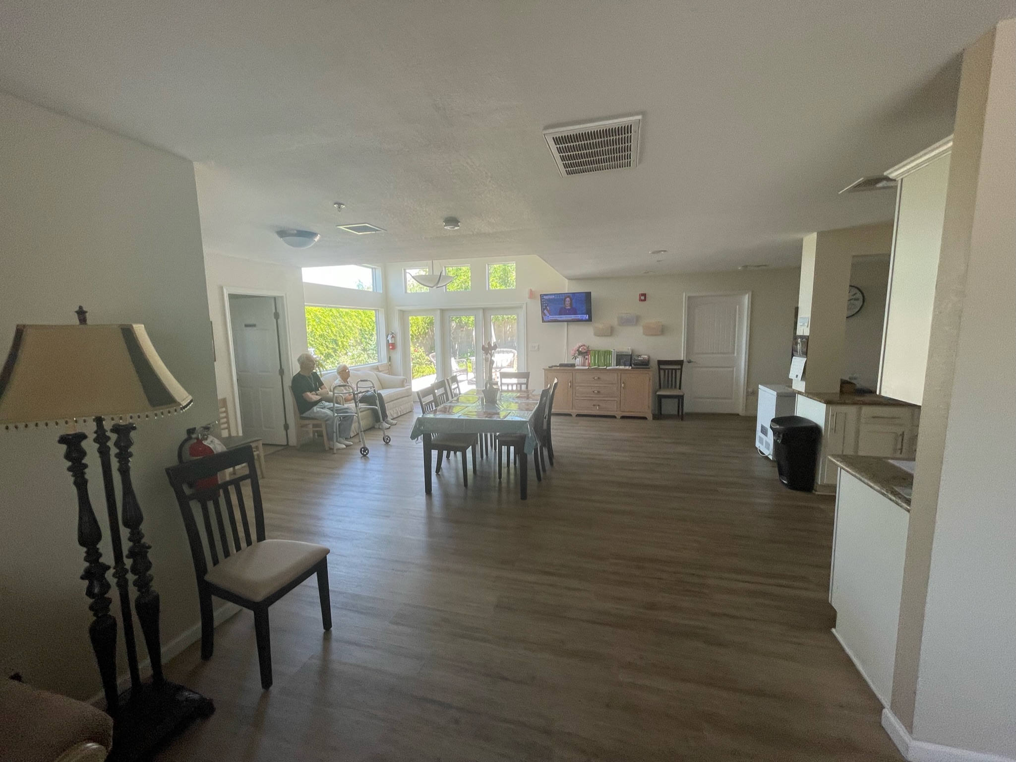 Light-filled common area with residents and a view outside